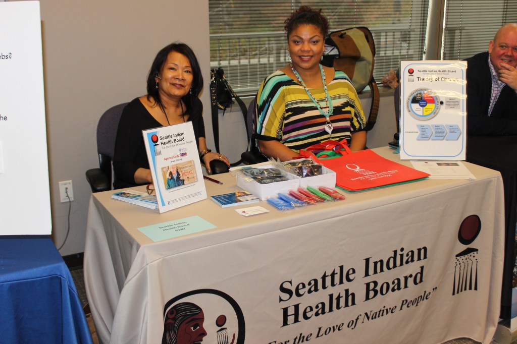 Seattle Indian Health Board staff pose for a photo at their table during the Employee Giving Program's Nonprofit Expo on November 17, 2017.